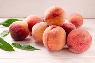 Fresh peaches on a wooden table. Summer peach fruit background.