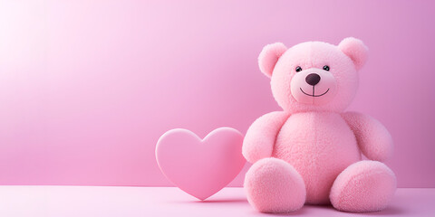 Pink teddy bear with a pink heart on a pink background. Banner for Valentine's Day with copy space.