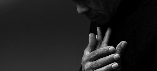 praying to god with hands together Caribbean man praying with black background with people stock photo - obrazy, fototapety, plakaty