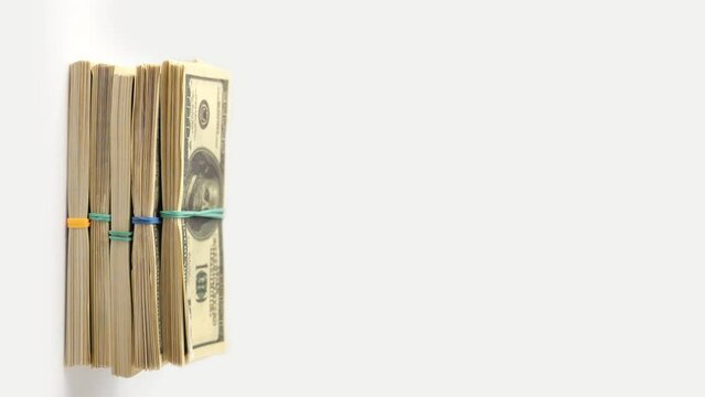 Dollars money up, increasing income concept. Vertical video of stacks of hundred dollar bills piling up into large stack of US dollars money. Close up, copy space