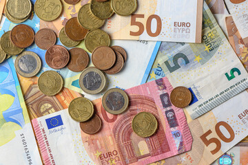 Euro bills and coins scattered on the table as a background 6