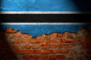 A wall with a painting of the botswana flag at night.