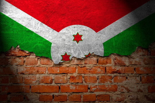 A wall with a painting of the burundi flag at night.