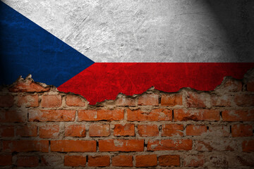 A wall with a painting of the czech flag at night.