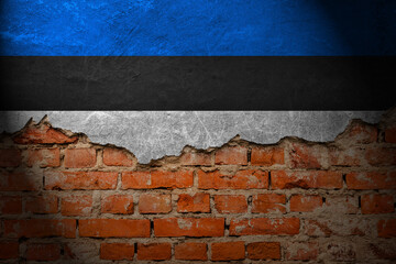 A wall with a painting of the estonia flag at night.