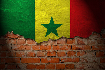 A wall with a painting of the senegal flag at night.