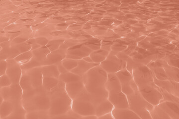 Soft pink textures with subtle light reflections, resembling a gentle marble surface.