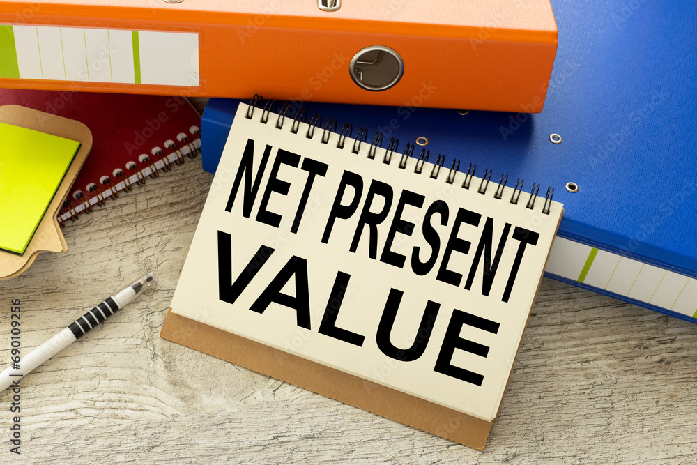 Poster net present value (npv) text on the page. notepad on paper folder