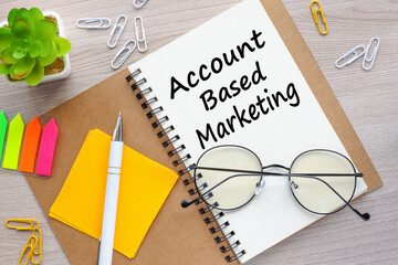 Account Based Marketing. glasses lie on a notepad. text on the page. bright stickers