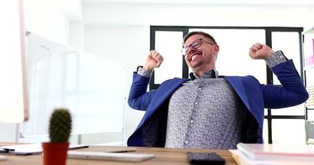 Successful cheerful businessman is typing on computer keyboard and enjoying life 4k movie. Business success and job satisfaction concept