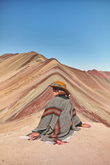 Young girl enjoying in front of the Vinicunca Rainbow Mountain, Peru South America