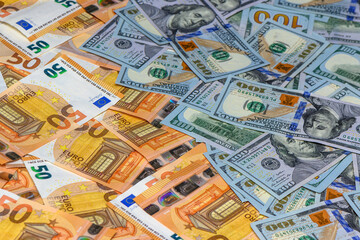 50 euro and 100 dollar bills scattered on the table as a background 12