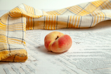 Saturn peach or flat peach on white wooden background..