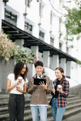  Students are studying the campus park. Young people are spending time together. Reading book, working with laptop, tablet and communicating while