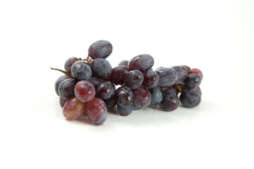 Bunch of organic black grapes isolated on white background.