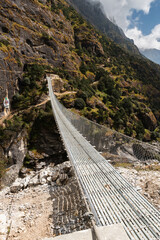 Landscape with Suspension Bridge over Bhote Kosi River during Three passes trekking in Sagarmatha...