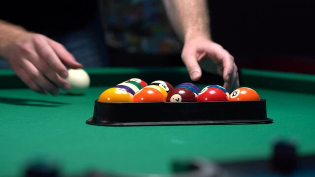 Racking the balls for the first break in pool game