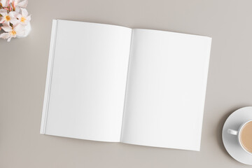 Open magazine mockup with a oleander on the beige table.
