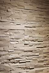 Rustic texture wall brick sandstone with shadows and deep texture interior background photo.