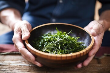 man having seaweed salad in a bamboo bowl