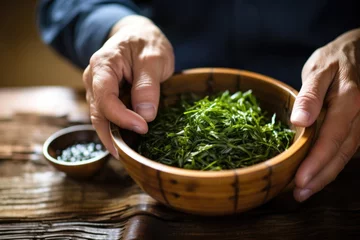 Keuken spatwand met foto man having seaweed salad in a bamboo bowl © primopiano