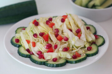 Salad made of cucumber lettuce and pomegranate