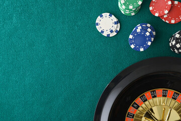 Casino roulette background on mat and betting chips in corner