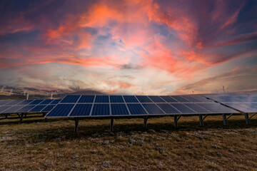 Mountain landscape in winter with snow and a photovoltaic system at sunset. Solar panels for the...