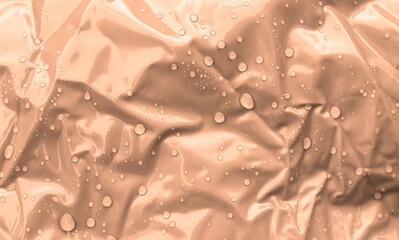 Peach fuzz texture background with water drops, trendy color of the year 2024
