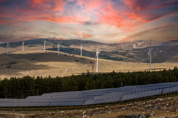 Mountain landscape in winter with snow and a photovoltaic system at sunset. Solar panels for the green economy and technology are the only solution to protect the planet from climate change and global