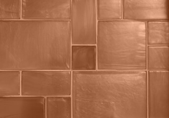 Background of ceramic tiles in new trendy color of 2024 Peach Fuzz. Monochrome. Abstract. Wallpaper for blogs in social networks. Copy space