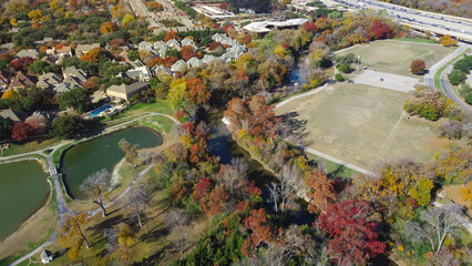 Colorful fall foliage at Park Central with luxury lakeside residential houses, soccer fields, White...