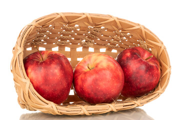 Three ripe juicy apples in a basket, macro, isolated on white background.