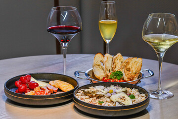Elegant dining setup with wine and gourmet dishes. Fine dining and wine pairing.