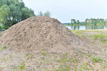 A pile of sand on the riverbank.