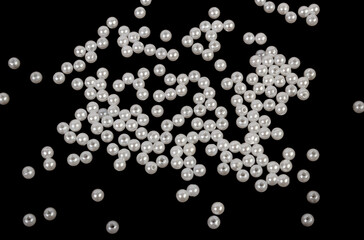 White beads on a black background