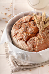 Fresh loaf of round bread freshly baked in home bakery.