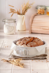 Healthy loaf of round bread freshly baked in home bakery.