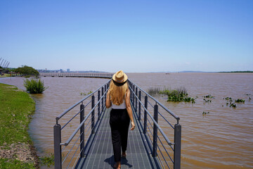 Girl walks on attraction in Orla do Guaiba, Porto Alegre, Rio Grande do Sul, Brazil