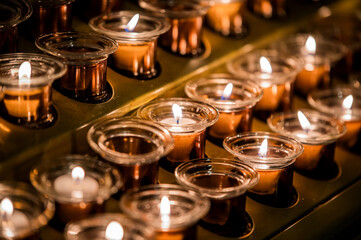Fototapeta na wymiar Set of burning candles in darkness