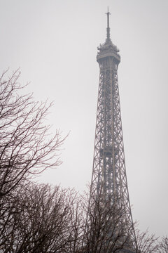 The top of the Eiffel Tower in the autumn mist in Paris
