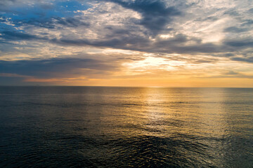 In morning sun rises over water waves of ocean