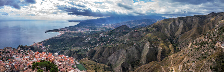 Fototapeta premium Stunning panorama of hills and the Sicilian coast from Castelmola in Sicily, Italy