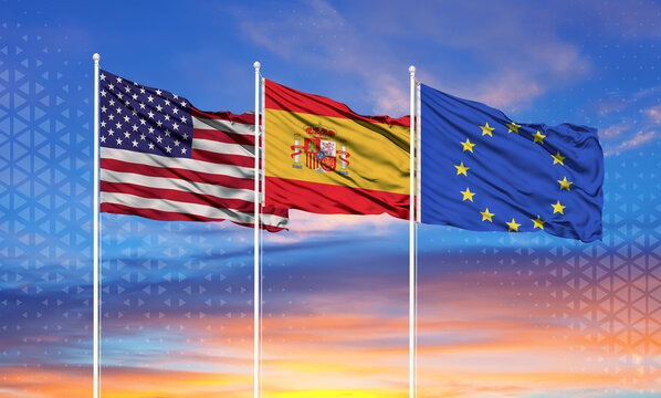 Three realistic flags of European Union, United States and Spain on flagpoles and blue sky.