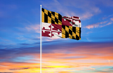 Maryland flag on flagpoles and blue sky.