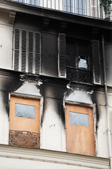 Typical Parisian building exterior after fire. Burnt charred wall. Temporary renovation. Paris, France. Real estate insurance importance concept.