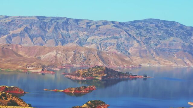 Beautiful view of Nurek Reservoir with blue lake and high mountains against the sky