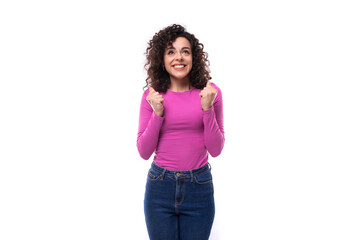 young curly brunette lady is dressed in a trendy lilac turtleneck on a white background