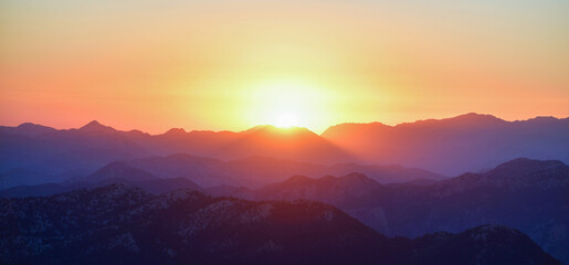 The Lights of the Setting Sun over the Mountain Range - Powered by Adobe