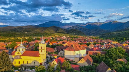Aerial stunning view of a historic town, surrounded by the picturesque Fagaras mountains
